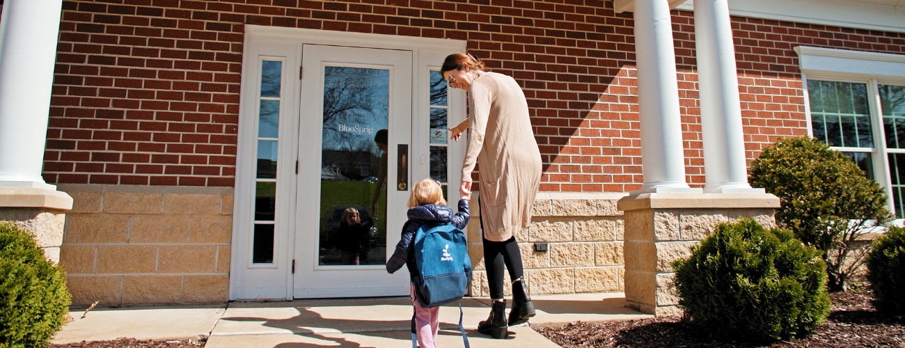 Young Girl Holding Adults Hand and Walking into BlueSprig Office