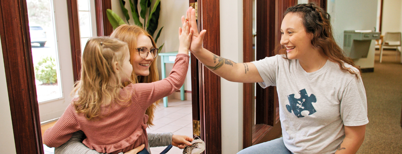 Young Girl High Fiving BlueSprig Staff Member