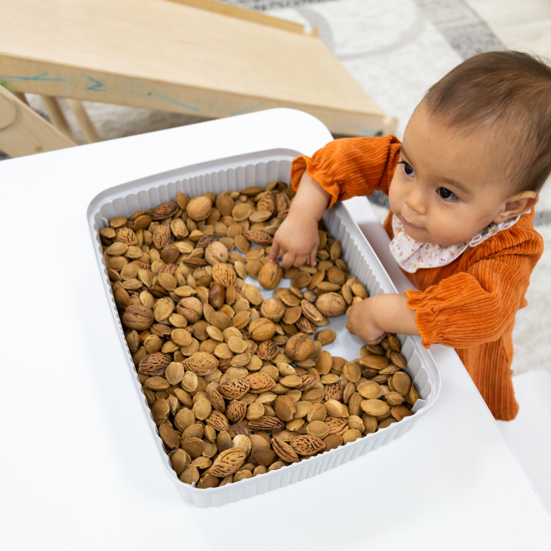 small child playing with a sensory bin