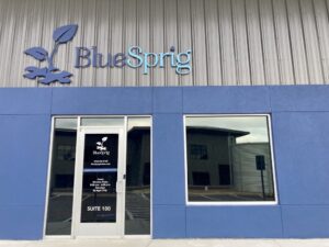 Front of BlueSprig center in Magnolia, Texas. A blue concrete building.
