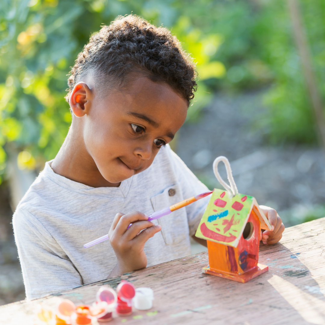 Boy Painting a Birdhouse