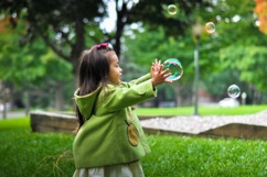 little girl playing with bubbles