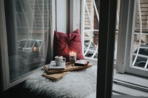 pillow and tea with a candle by the window