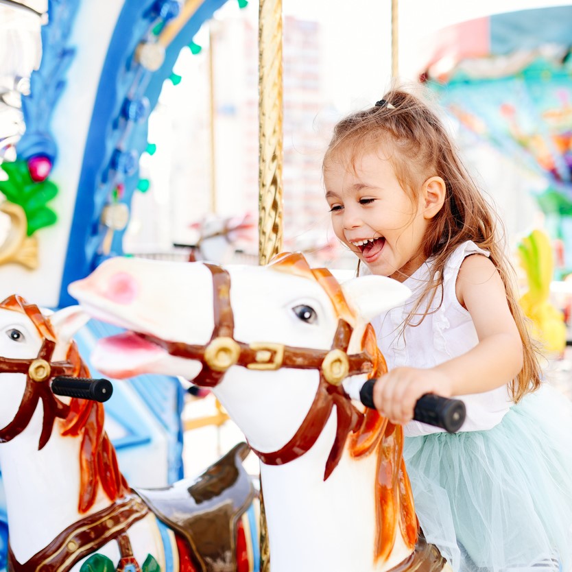 Girl Riding Horse on Carousel 