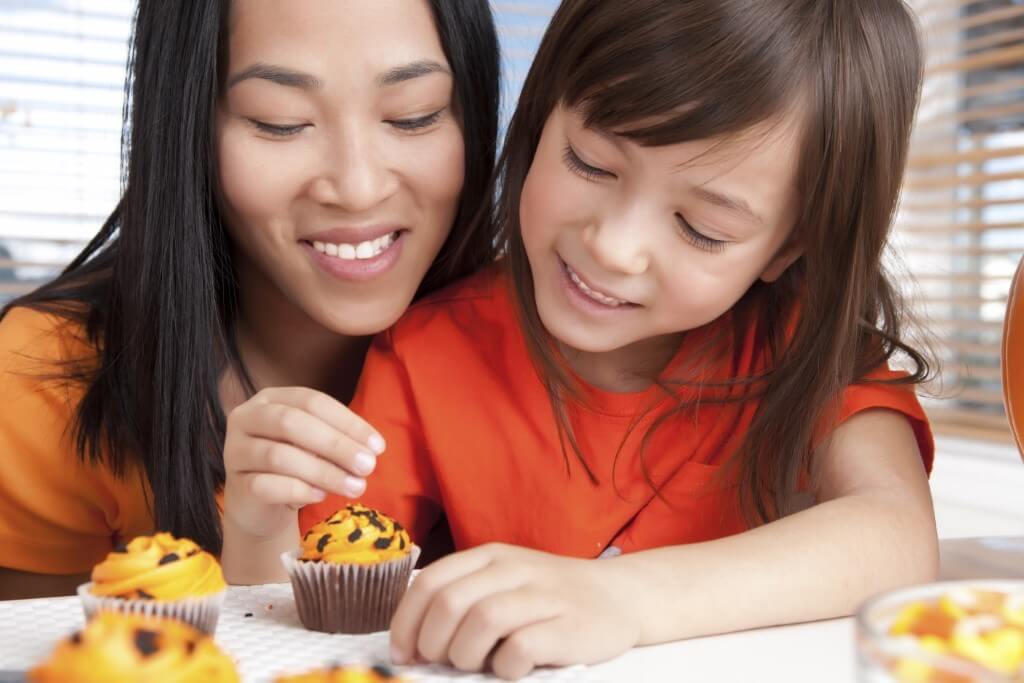 mother and child decorating cupcakes