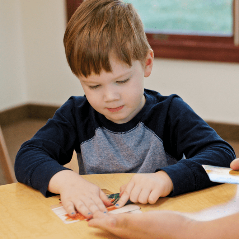 Young child playing with paper
