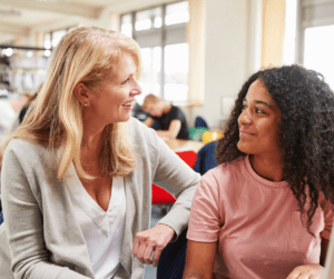 Two adult women talk at an aba therapy center.