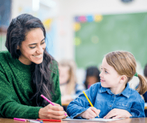 A teacher looks at her young student.