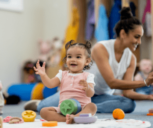A toddler plays with colorful toys.