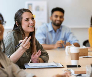 Female BCBA talks to other people.