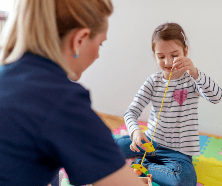 BCBA watches young girl play.