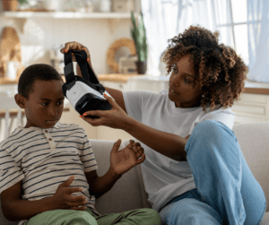 Parent puts VR headset on child.