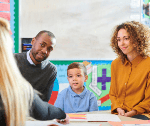 Parents and child talk to ABA therapist.