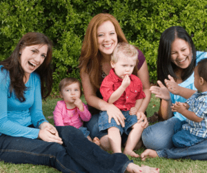 Three autism parents play outside with three small children.